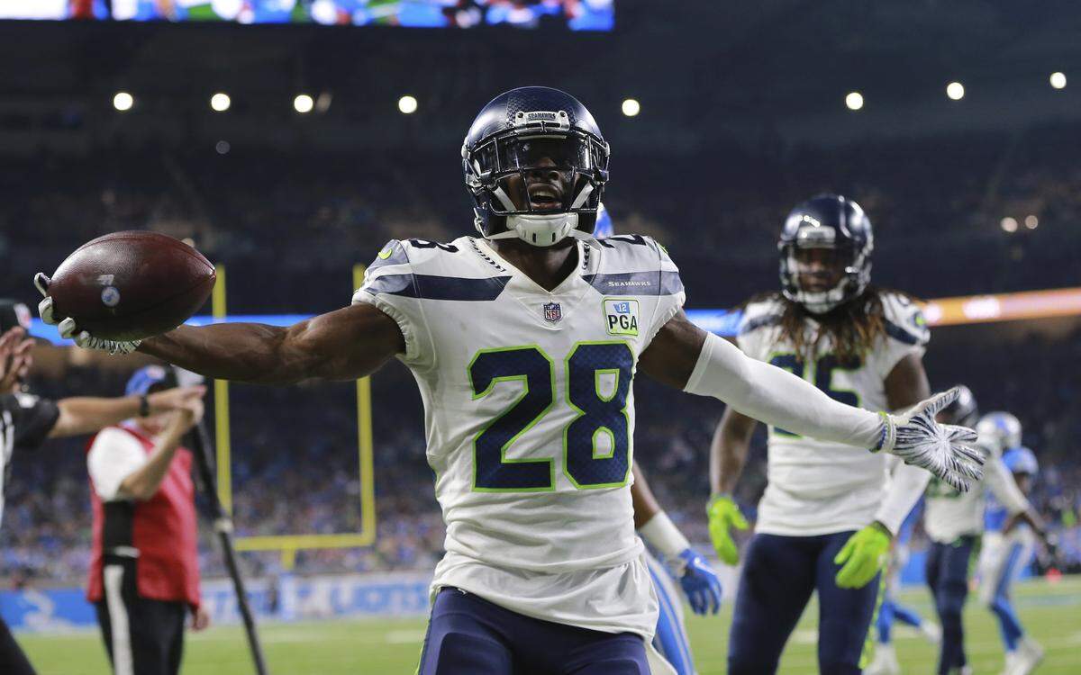 Seahawks nickel defensive back Justin Coleman (28) reacts after his interception of Matthew Stafford’s pass at the goal line intended for Lions and ex-Seattle wide receiver Golden Tate late in the Seahawks’ win at Detroit last weekend.