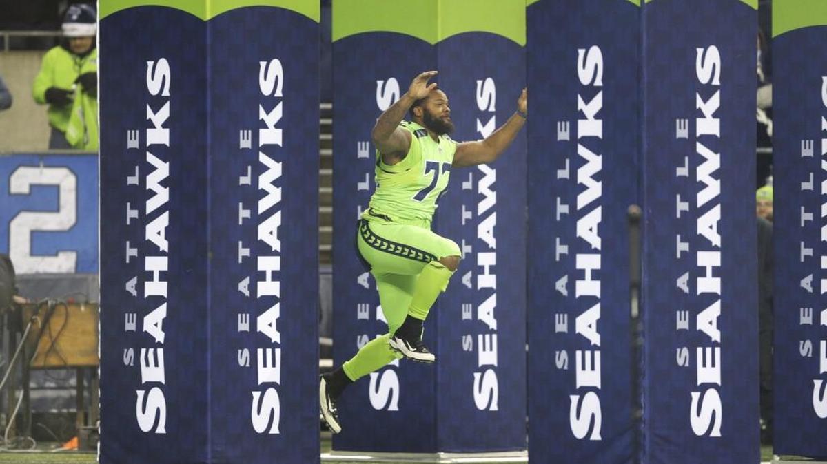 Seattle Seahawks defensive end Michael Bennett leaps in the air as he is introduced before an NFL football game against the Los Angeles Rams, Thursday, Dec. 15, 2016, in Seattle.