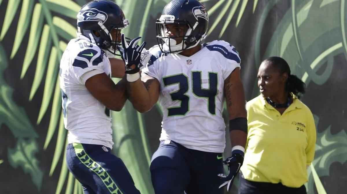 
Seattle Seahawks running back Thomas Rawls (34) celebrates his touchdown with wide receiver Tyler Lockett, left, in the second half Sunday. The undrafted rookie rushed for 169 yards on 23 carries. 
