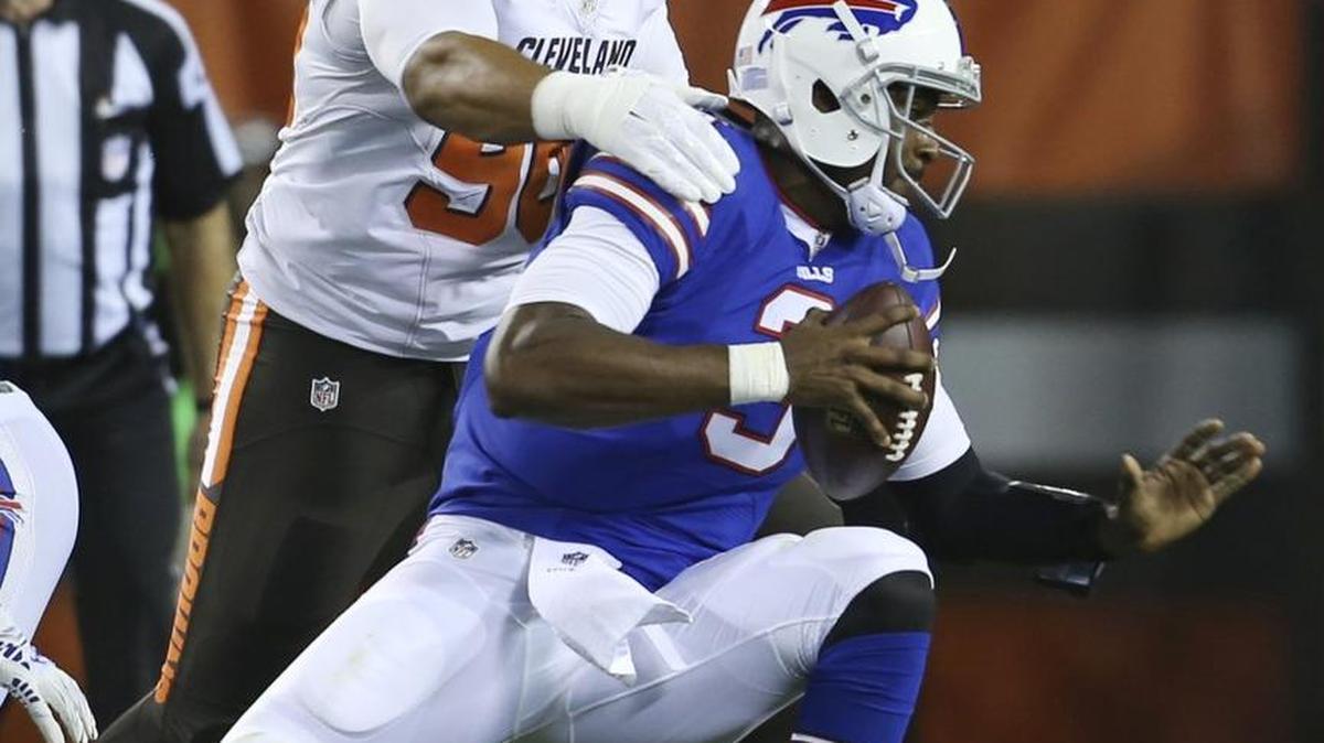Wilson High grad and Browns defensive tackle Xavier Cooper, left, sacks Bills quarterback EJ Manuel during a preseason game in August.