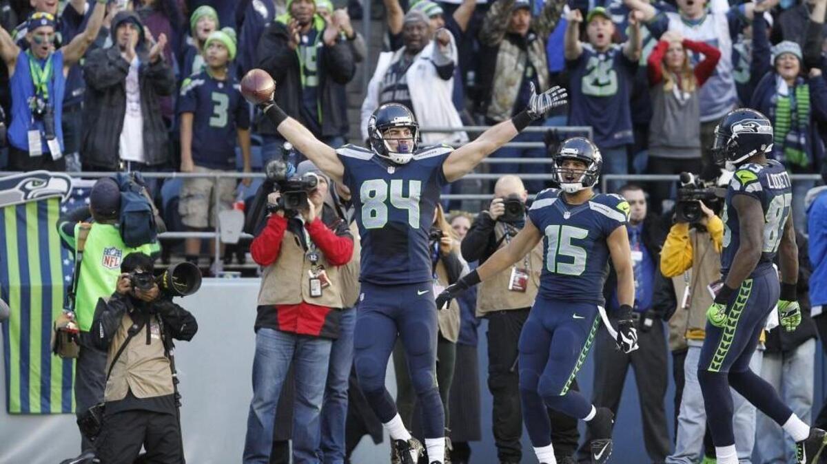 Seahawks tight Cooper Helfet celebrates his 20-yard touchdown reception - the second of his two career TD catches -- against Arizona Cardinals at on Nov. 23, 2014. Surgery for a broken bone in his foot lengthen the odds of him being on this season’s team.