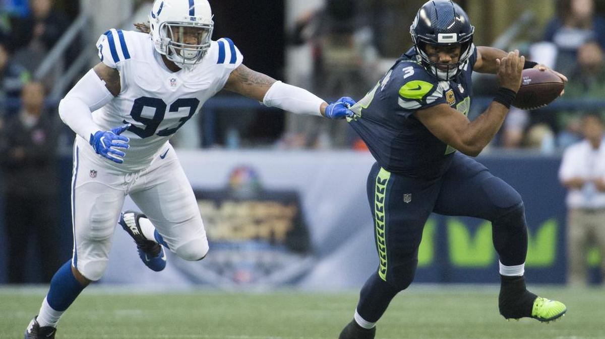Seahawks quarterback Russell Wilson trires to escape from Colts linebacker Jabaal Sheard in the first quarter. quarter. The Seattle Seahawks played the Indianapolis Colts in a NFL football game at CenturyLink Field in Seattle, Wash., on Sunday, Oct. 1, 2017.