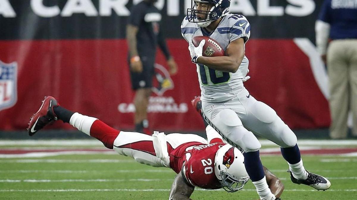 Seattle Seahawks wide receiver Tyler Lockett (16) breaks the tackle of Arizona Cardinals strong safety Deone Bucannon (20) during the first half of an NFL football game, Sunday, Jan. 3, 2016, in Glendale, Ariz.