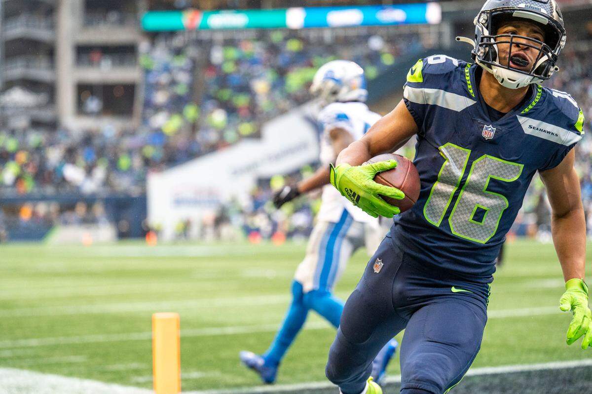 Seattle Seahawks wide receiver Tyler Lockett (16) scores a touchdown in the final minute of the first half of an NFL game against the Detroit Lions on Sunday, Jan. 2, 2022, at Lumen Field in Seattle.