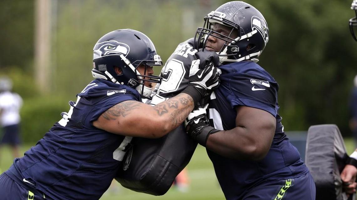 Kona Schwenke, left, runs a drill against then-Seahawks rookie offensive lineman Germain Ifedi, during an offseason practice in 2016. Agent Jerry Marlatt said Sunday Schwenke's father called him Sunday to tell him Schwenke died in his sleep at age 25.