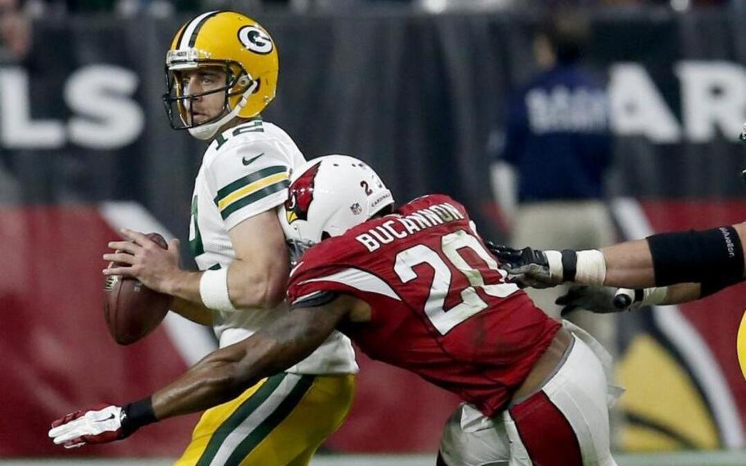 Green Bay Packers quarterback Aaron Rodgers (12) fumbles as he is sacked by Arizona Cardinals strong safety Deone Bucannon (20) during the second half of an NFL football game, Sunday, Dec. 27, 2015, in Glendale, Ariz. The Packers recovered the football.