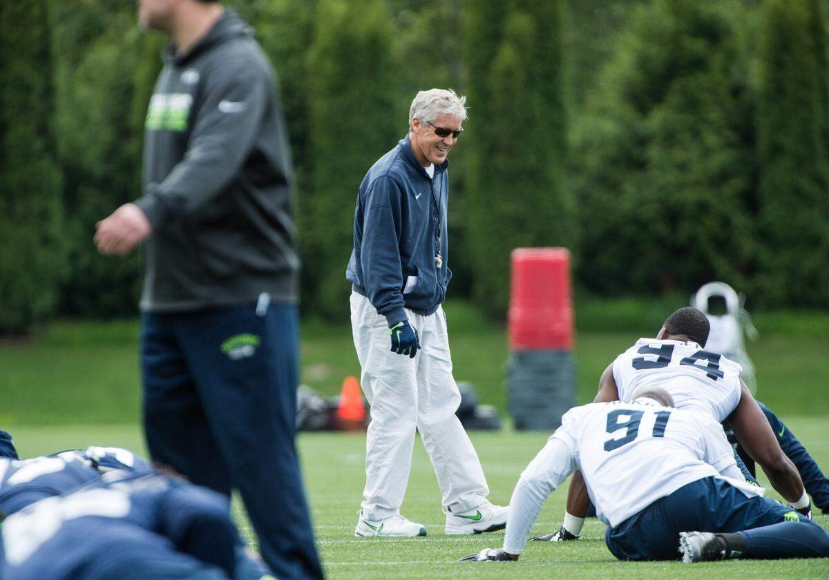 Coach Pete Carroll talks with rookie defensive end Rasheem Green (94) during the Seahawks' rookie minicamp last month at the Virginia Mason Athletic Center in Renton. Green was the team's third-round pick in the NFL draft. He is learning the hybrid tackle-end role former Pro Bowl pass rusher Michael Bennett had for Seattle.
