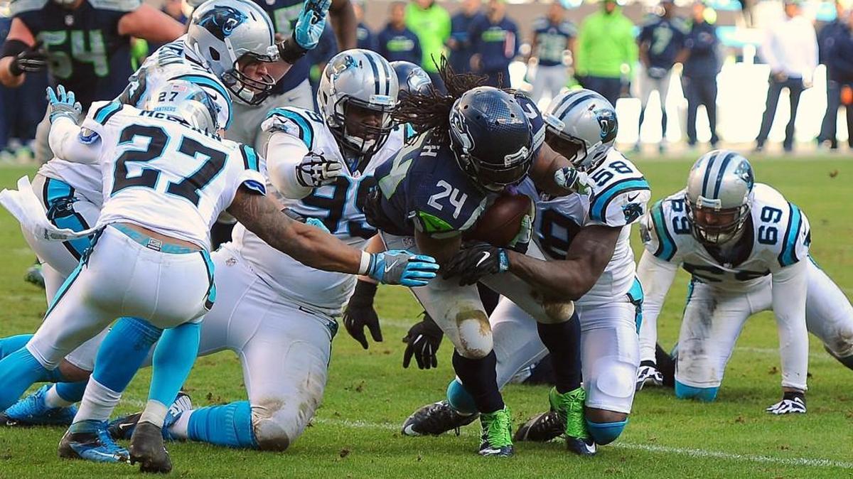 The Carolina defense brings down Seattle running back Marshawn Lynch, center, during fourth quarter action at Bank of America Stadium on Sunday. The Panthers beat the Seahawks, 31-24, and advanced to the NFC title game.