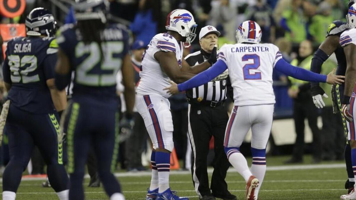 Then-Buffalo Bill Dan Carpenter (2) complains to referee Walt Anderson after former Seahawk Richard Sherman (25) ran into the kicker during a game in Seattle in 2016. Anderson, a 17-year veteran referee with a reputation for throwing flags, will head an all-star officiating crew on the Seahawks’ wild-card playoff game at Dallas Saturday night.