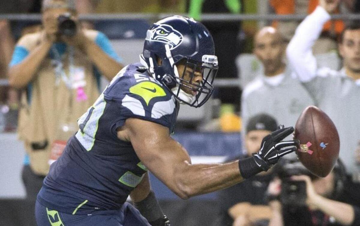 
Seahawks linebacker K.J. Wright reaches for Calvin Johnson’s fumble before the ball went out of the back of the end zone. Some think that an illegal batting penalty should have been called.
