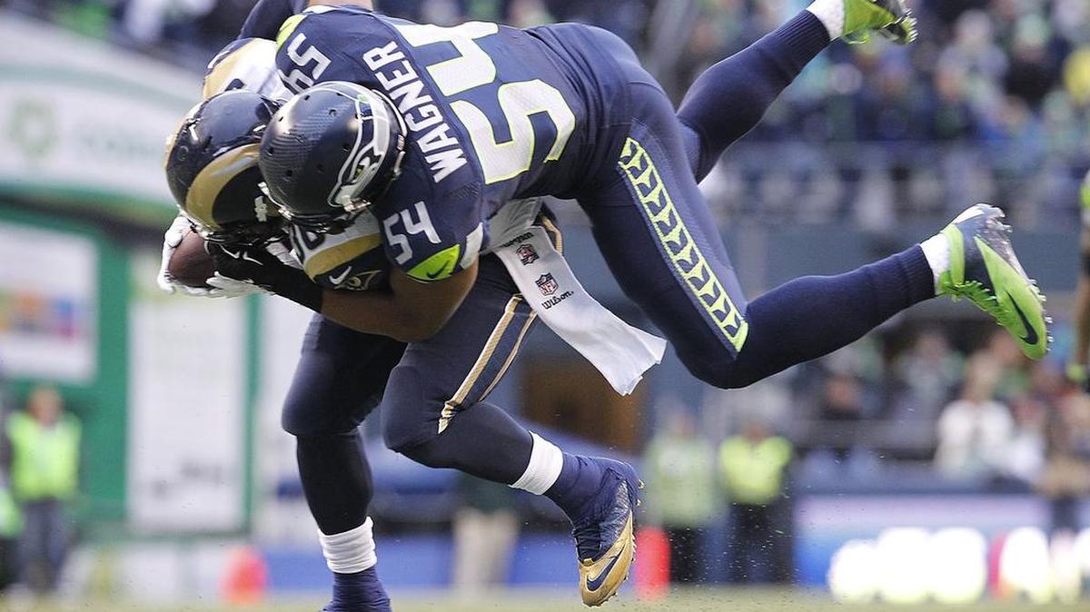 
Seahawks linebacker Bobby Wagner tackles Rams running back Benny Cunningham last season. Wagner signed a four-year extension Saturday night to become the richest middle linebacker in league history.
