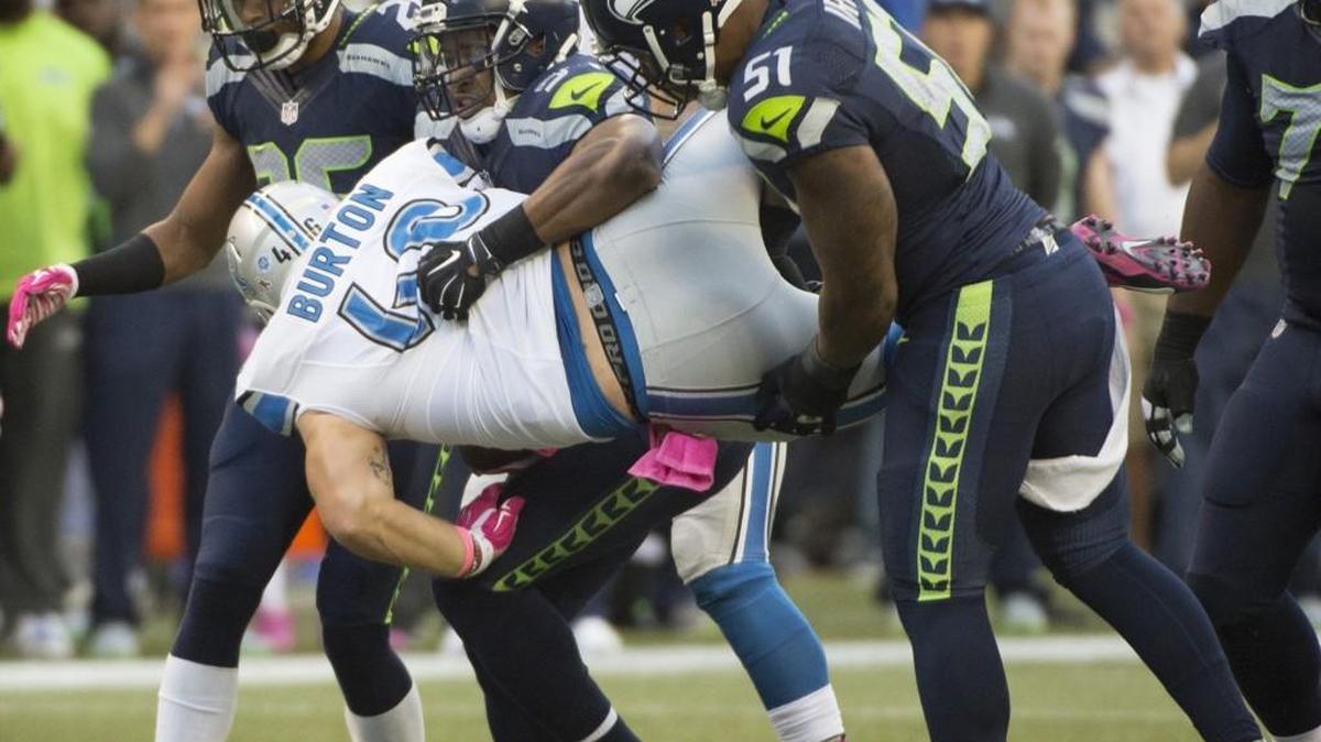 
Lions fullback Michael Burton is tossed around by Seahawks defenders (from left) Cary Williams, Bobby Wagner and Bruce Irvin during the Monday Night Football game at CenturyLink Field in Seattle on Oct. 5, 2015.
