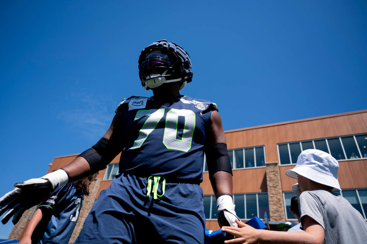 Seattle Seahawks guard Laken Tomlinson (70) gets fans during the first day of training camp at the Virginia Mason Athletic Center, on Wednesday, July 24, 2024, in Renton, Wash.