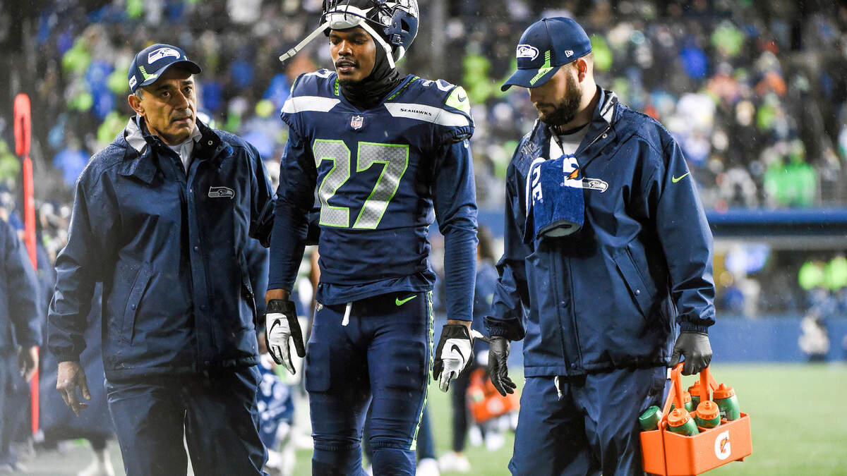 Seattle Seahawks defensive back Marquise Blair (27) is helped off the field after an injury in the fourth quarter of an NFL game against the New Orleans Saints on Monday night at Lumen Field in Seattle.