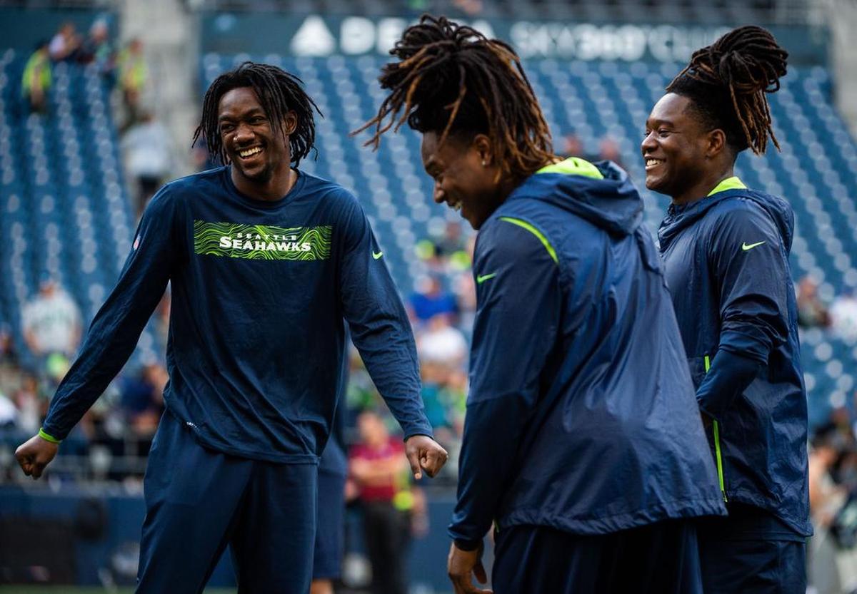 From left: Rookie cornerback Tre Flowers, starting cornerback Shaquill Griffin, and rookie Seahawks linebacker Shaquem Griffin, Shaquill’s twin, share a laugh during warmups before the Seahawks’ preseason game last week against Oakland.
