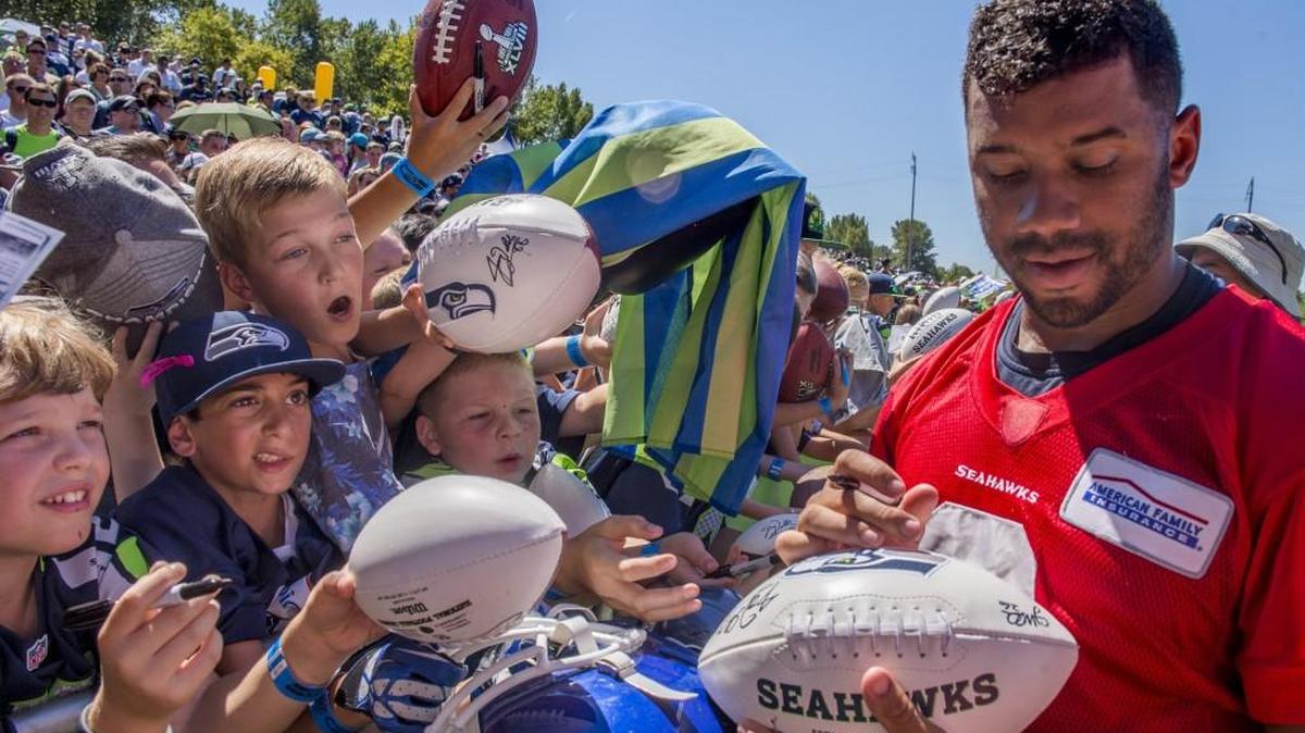 Fans will be able to watch 12 Seahawks practices and get autographs from quarterback Russell Wilson and his teammates during training camp that begins July 26. The team on Monday announced the practices at the Virginia Mason Athletic Center that will be open to the public, after fans register online.
