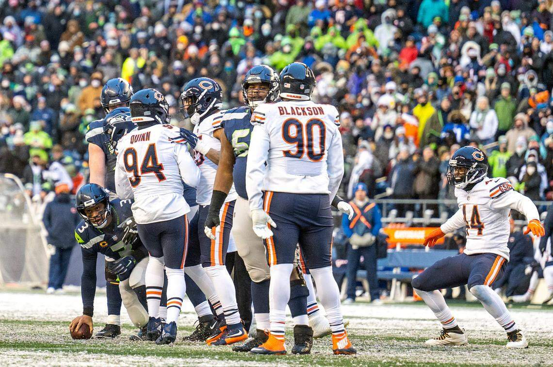 Chicago’s defense celebrates after outside linebacker Robert Quinn (94) sacked Seattle Seahawks quarterback Russell Wilson (3) for a big loss on third down in the fourth quarter of an NFL game on Sunday afternoon at Lumen Field in Seattle.