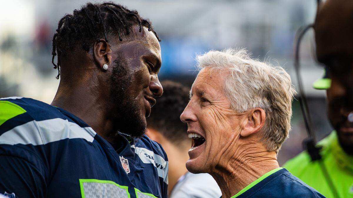 Defensive end Frank Clark (left) and coach Pete Carroll will continue to smile on the Seahawks’ sideline in 2019. Carroll reiterated at the NFL combine Thursday that though Clark’s contract is expiring “Frankie will be with us”--and not leaving in free agency that begins in two weeks. Now, by what method will the Seahawks be keeping him?