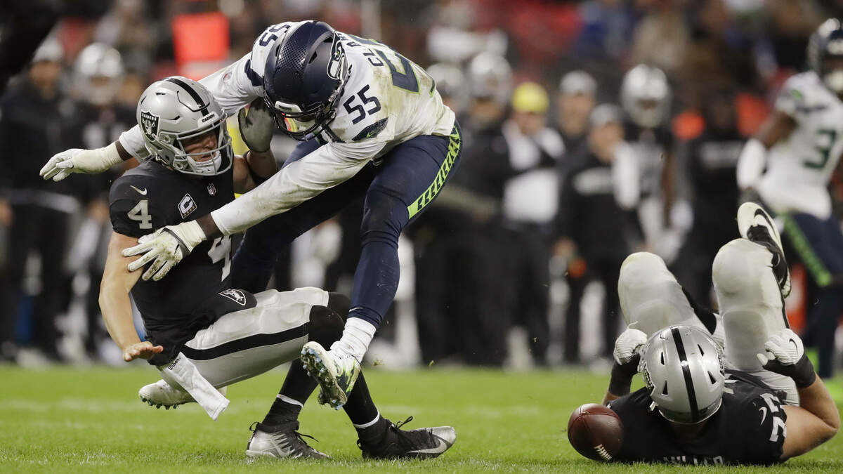 Frank Clark (55) is coming off the most dominant game of his career: 2 1/2 sacks of and two forced fumbles by Raiders quarterback Derek Carr (4) in the Seahawks’ rout of Oakland Oct. 14 in London. Clark’s rookie contract ends at the end of this season. He made it clear on Wednesday that he wants to remain a Seahawk for as long as he can see.