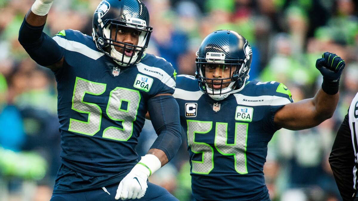 Seahawks defensive lineman Jacob Martin (59) and Seahawks linebacker Bobby Wagner (54) celebrate a strip sack of Cardinals quarterback Josh Rosen in the second quarter. The Seattle Seahawks played the Arizona Cardinals in a NFL football game at CenturyLink Field in Seattle, Wash., on Sunday, Dec. 30, 2018.