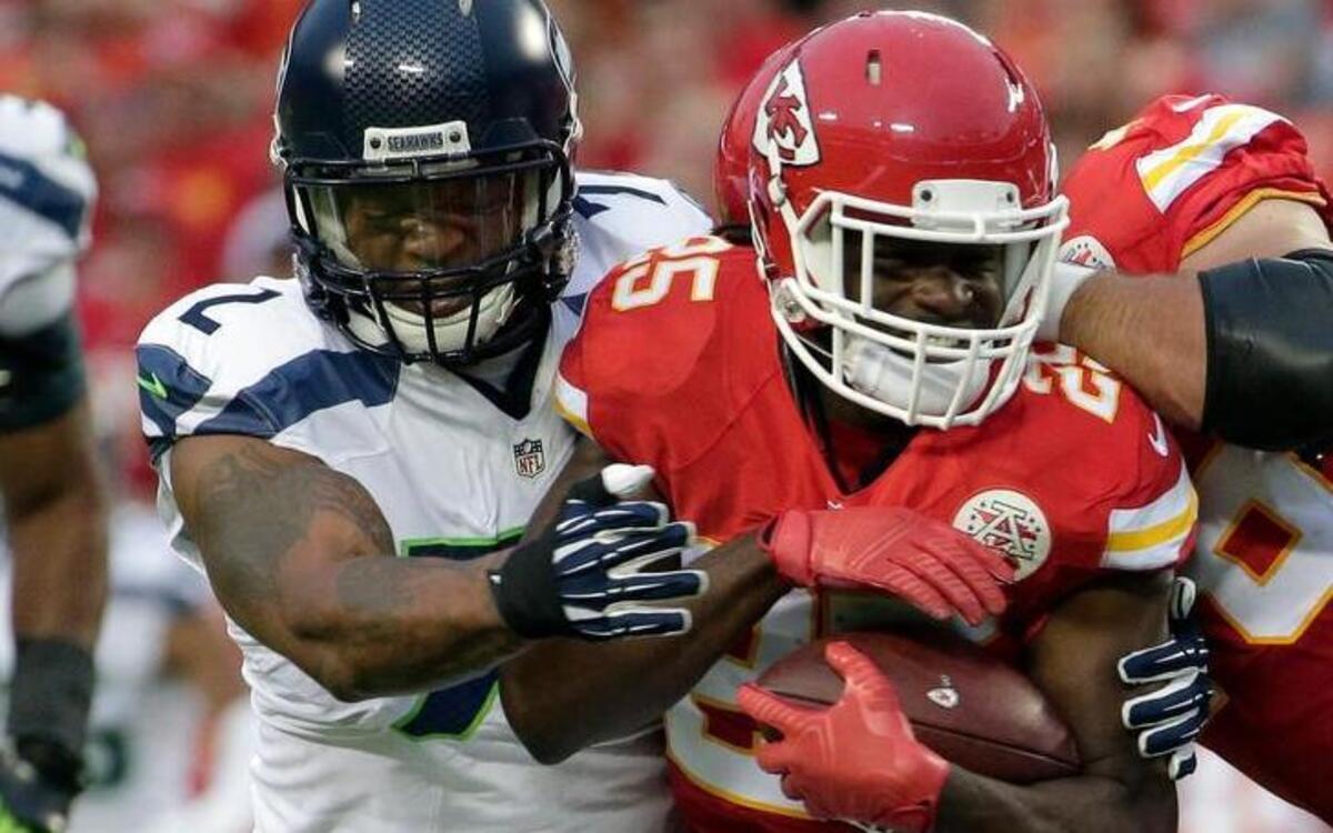 
Kansas City Chiefs running back Jamaal Charles (25) is tackled by Seattle Seahawks defensive end Michael Bennett (72) during the first half of an NFL football game at Arrowhead Stadium in Kansas City, Mo., Friday, Aug. 21, 2015.
