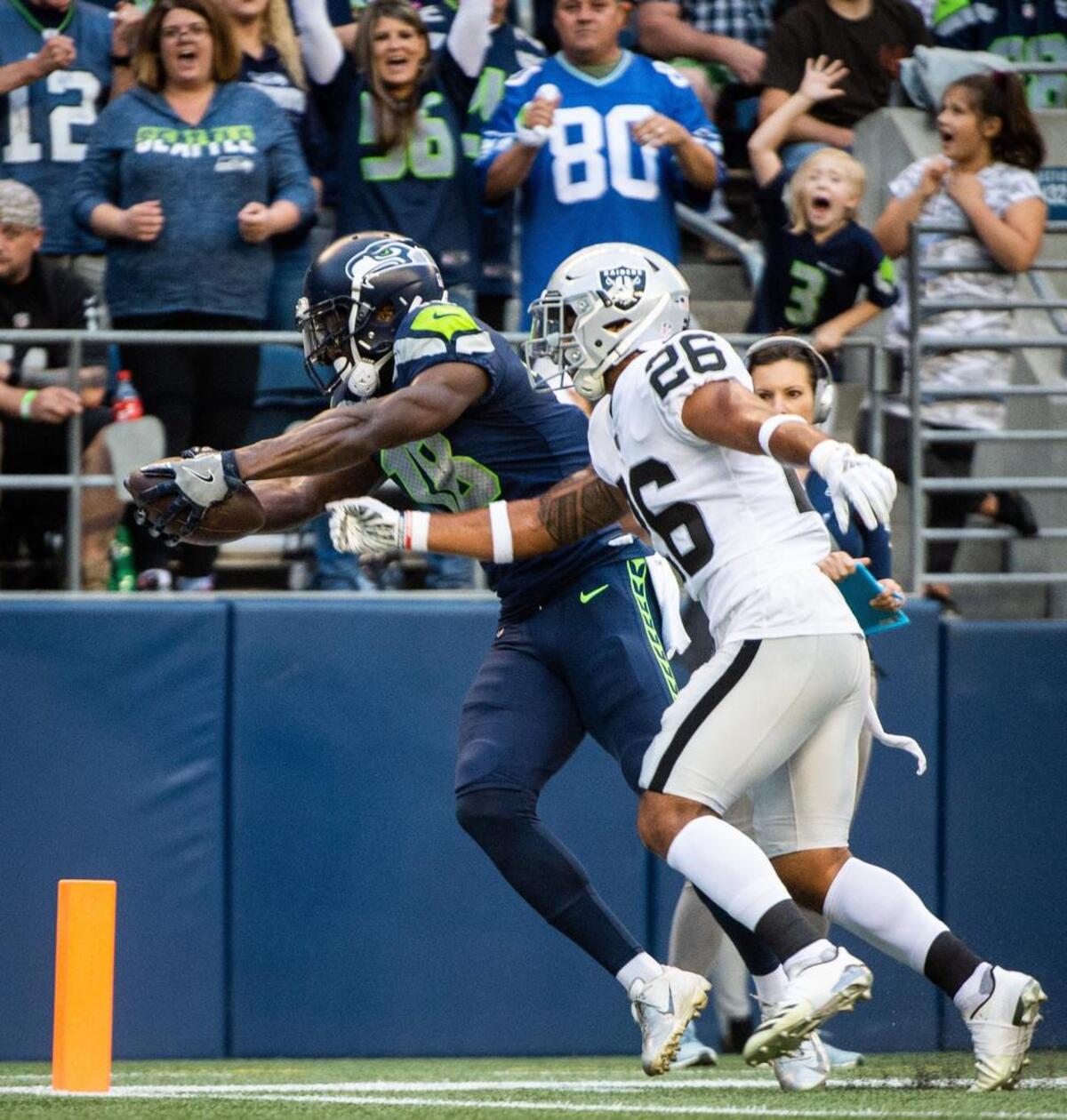 Former Arizona Cardinals wide receiver Jaron Brown (18) stretches for a touchdown in the first quarter of Thursday’s final preseason game for the Seahawks against Oakland. Though the play was called back after a holding penalty on tackle Isaiah Battle, Brown had already done plenty this preseason to win a spot on the 53-man roster for the regular season the Seahawks must set by Saturday at 1 p.m.