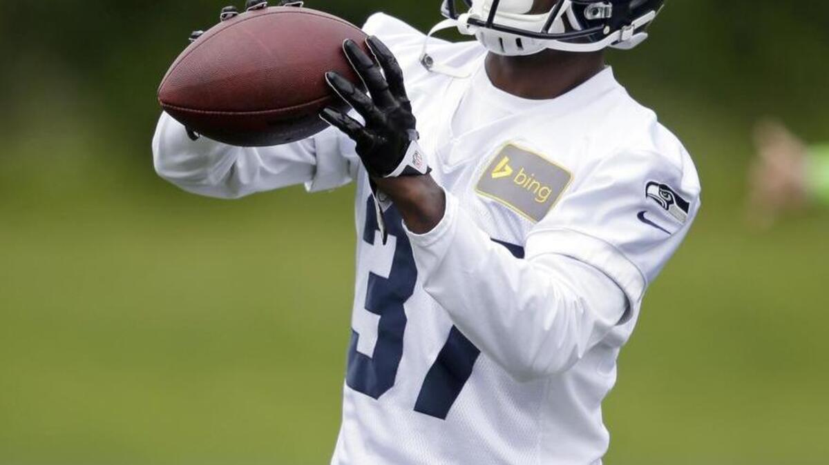 
Seattle Seahawks safety Dion Bailey works drills during an organized team activity practice in Renton in 2014. Bailey has moved up to the team’s top safety spot with Kam Chancellor holding out.
