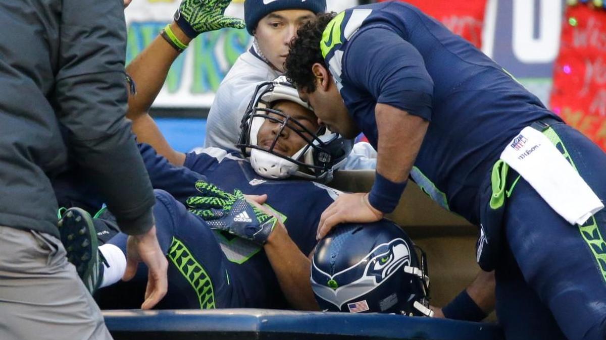 Seahawks receiver Tyler Lockett is embraced by Russell Wilson after being injured against the Arizona Cardinals in the first half on Saturday.
