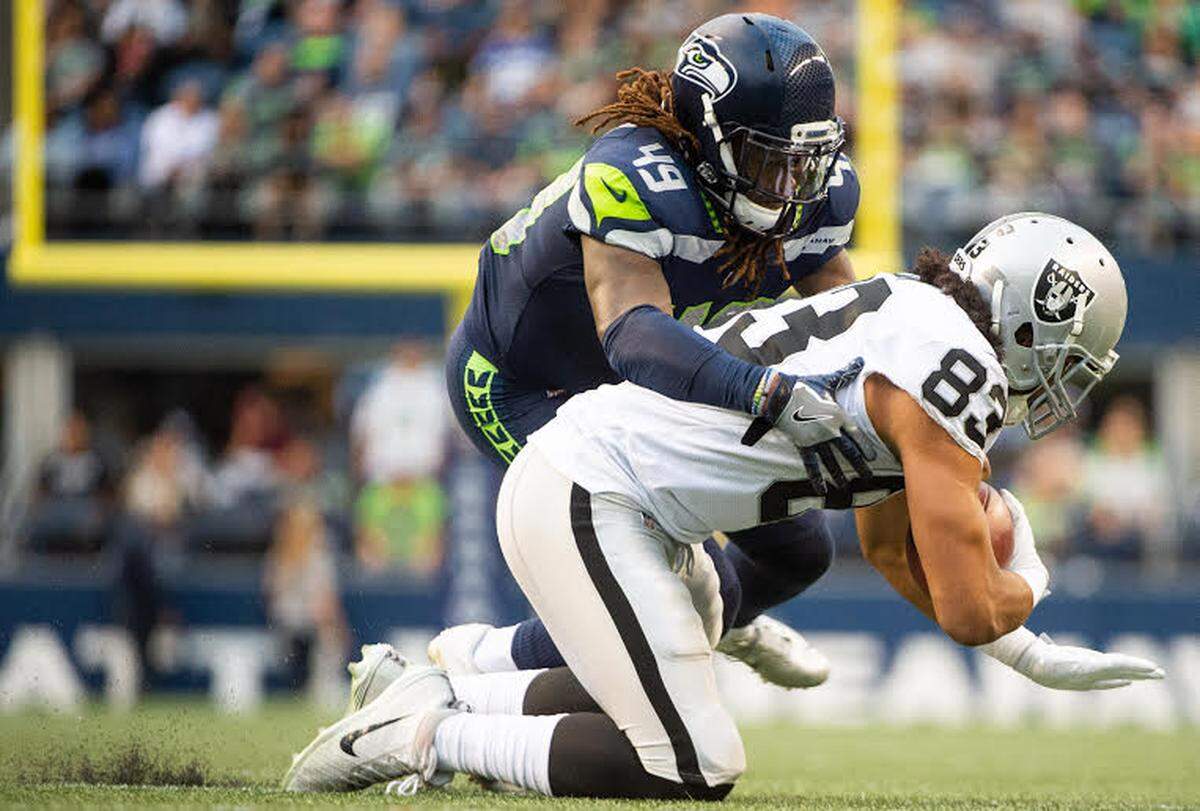 Rookie linebacker Shaquem Griffin makes one of his game-high seven tackles in the first half of Thursday’s preseason finale, on Raiders tight end Marcus Baugh in the first quarter. The remarkable fifth-round draft choice, the first one-handed player drafted into the modern NFL, accelerated his track to starting his first NFL in Denver Sept. 9, next to All-Pro Bobby Wagner in Seattle’s season opener.