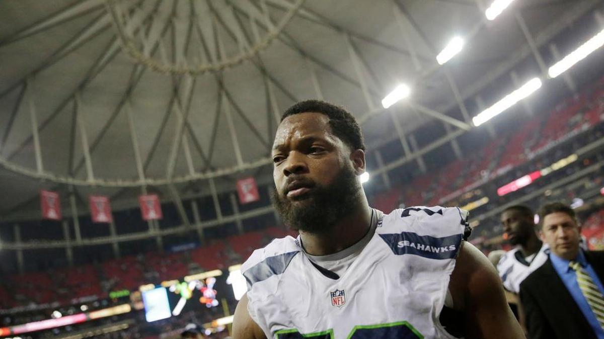 Seattle Seahawks defensive end Michael Bennett (72) walks off the field after a 36-20 loss to the Atlanta Falcons in a divisional playoff game in Atlanta. Bennett erupted at a reporter in the locker room after the loss.