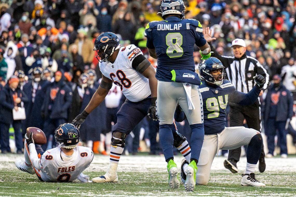 Seattle Seahawks defensive end Rasheem Green (94) celebrates after sacking Chicago Bears quarterback Nick Foles (9) in the fourth quarter of an NFL game on Sunday afternoon at Lumen Field in Seattle.