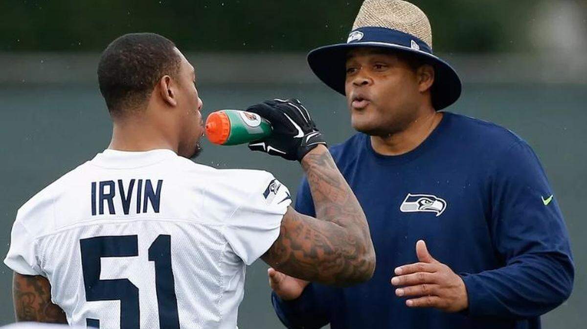 Bruce Irvin (51) and then-linebackers coach Ken Norton Jr. from early in their first go-rounds with the Seahawks, from 2012-15. The Oakland Raiders waived Irvin on Monday. The Seahawks are candidates to sign their former Super Bowl linebacker for the rest of this season, largely because of the relationship between Irvin and Norton, who is now Seattle’s defensive coordinator.