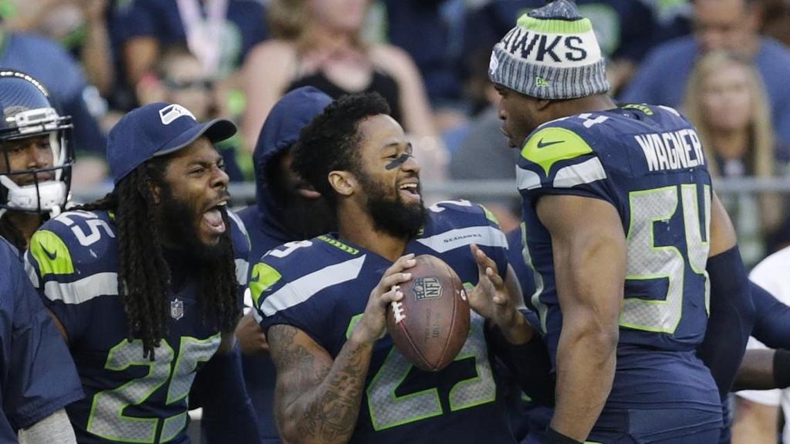 Seahawks’ All-Pro free safety Earl Thomas (29) and since-departed cornerback Richard Sherman (25) joke with All-Pro middle linebacker Bobby Wagner (54) during a preseason game last summer. Wagner told Seattle's KJR-AM radio Monday he understands why Thomas may hold out into Seattle's training camp that begins July 26. It's because teams hold the advantage in player contracts, thus players need to get their money however and whenever they can.
