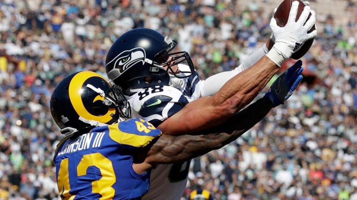 Seattle Seahawks tight end Jimmy Graham catches a touchdown pass under pressure from Los Angeles Rams defensive back John Johnson on Sunday during the first half in Los Angeles.