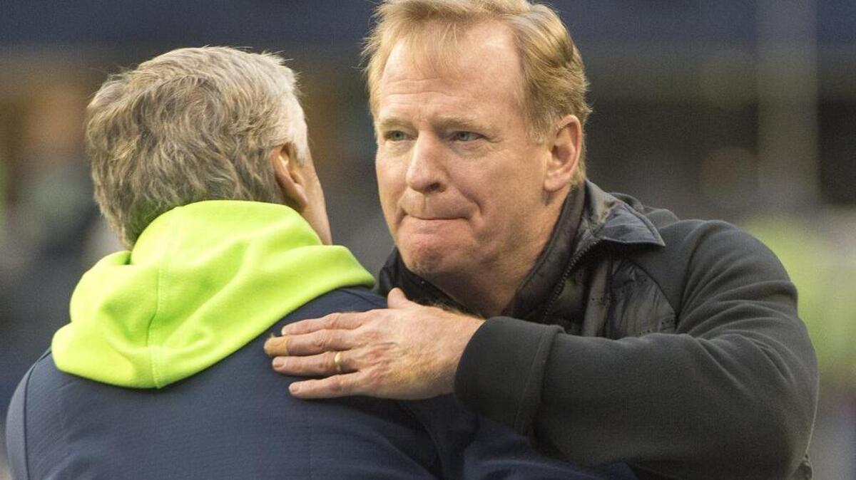 NFL commissioner Roger Goodell had long pregame chat with Seahawks coach Pete Carroll that ended with a hug. Photo taken in Seattle on Saturday, Jan. 7, 2017.