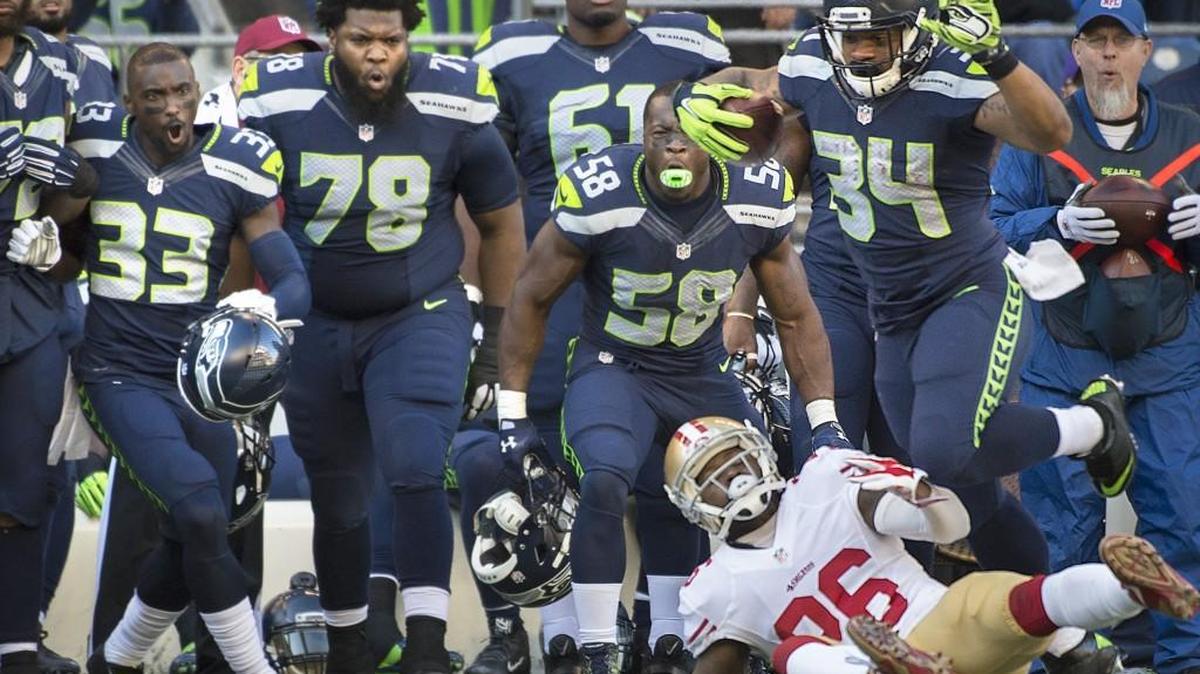 Teammates react as Seahawks running back Thomas Rawls (34) bowls over 49ers cornerback Tramaine Brock on Seattle’s second offensive play Sunday.