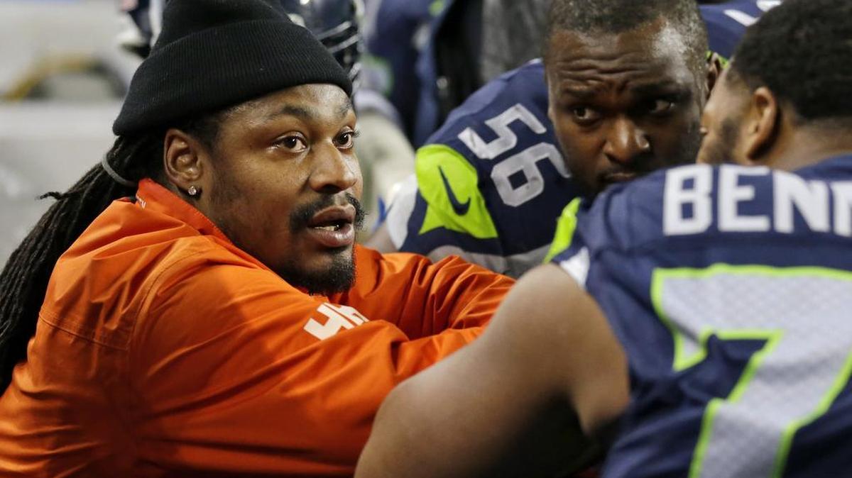 Marshawn Lynch visits with former Seahawks teammates Michael Bennett and Cliff Avril on the bench during a game against Carolina in December 2016, when he was retired--and before he returned to play for his hometown Oakland Raiders last season. Bennett, the three-time Pro Bowl defensive end Seattle traded to Philadelphia this month, said this week once Lynch left after the 2015 season the Seahawks were never the same.