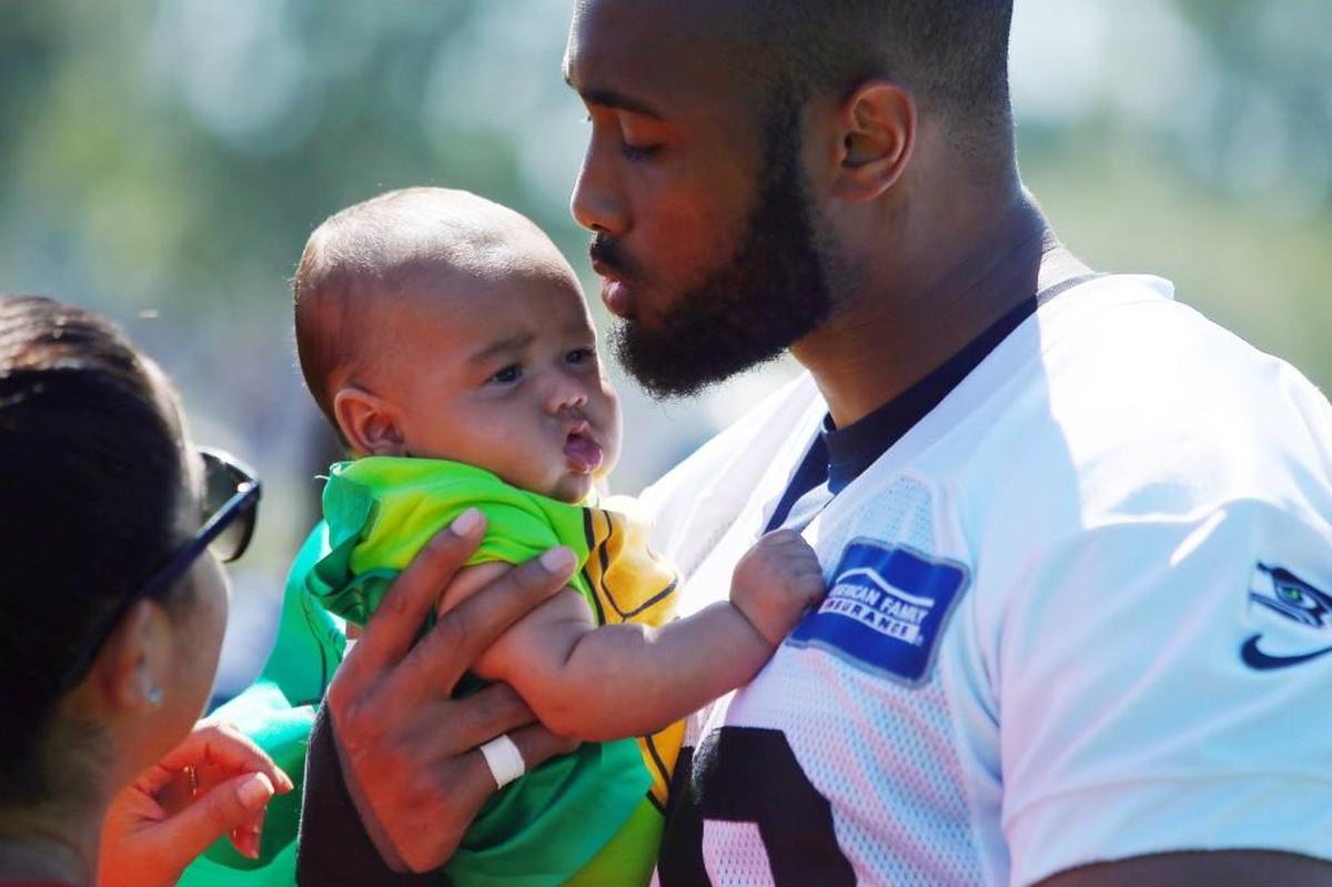 K.J. Wright holds his then-3-month-old son after a Seahawks preseason practice in August 2016. Kameron Joseph Wright is 3 now. His dad is mindful of when it will be time to retire from football and live a quality post-NFL life with his family.