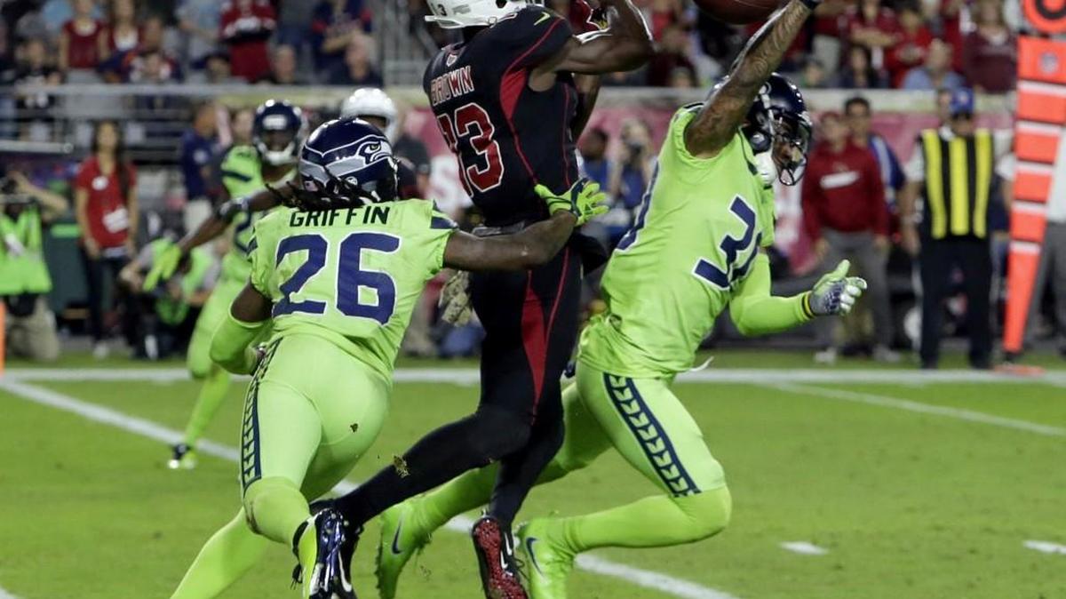 Wide receiver Jaron Brown (13) contends for a pass broken up by Seahawks safety Bradley McDougald, right, during Seattle’s win at Arizona in November. Friday night the Seahawks agreed to terms with the 28-year-old Brown on a free-agent contract.