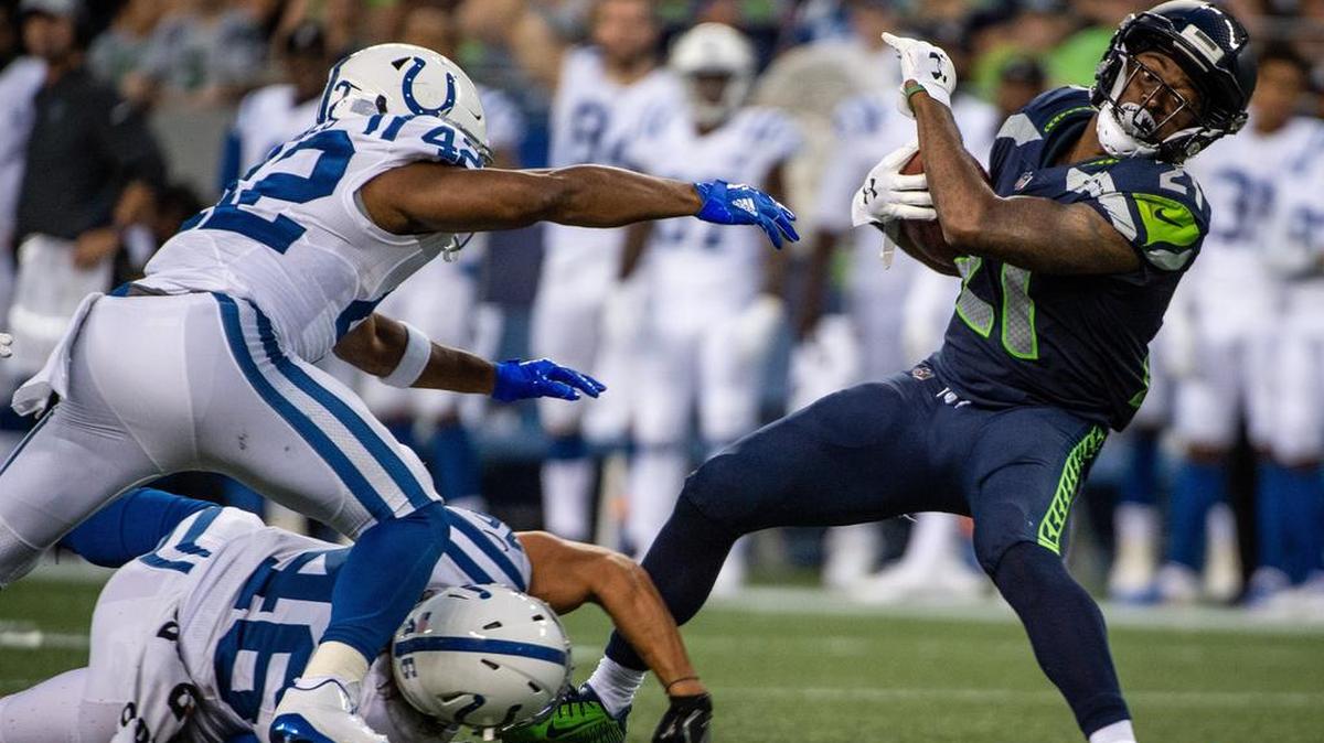 Seahawks running back and kick returner J.D. McKissic (21) escapes pressure from Colts long snapper Luke Rhodes and Colts running back Nyheim Hines during a return in Seattle’s preseason opener two weeks ago. A report Tuesday said McKissic has a broken bone in his foot and will miss four to six weeks.