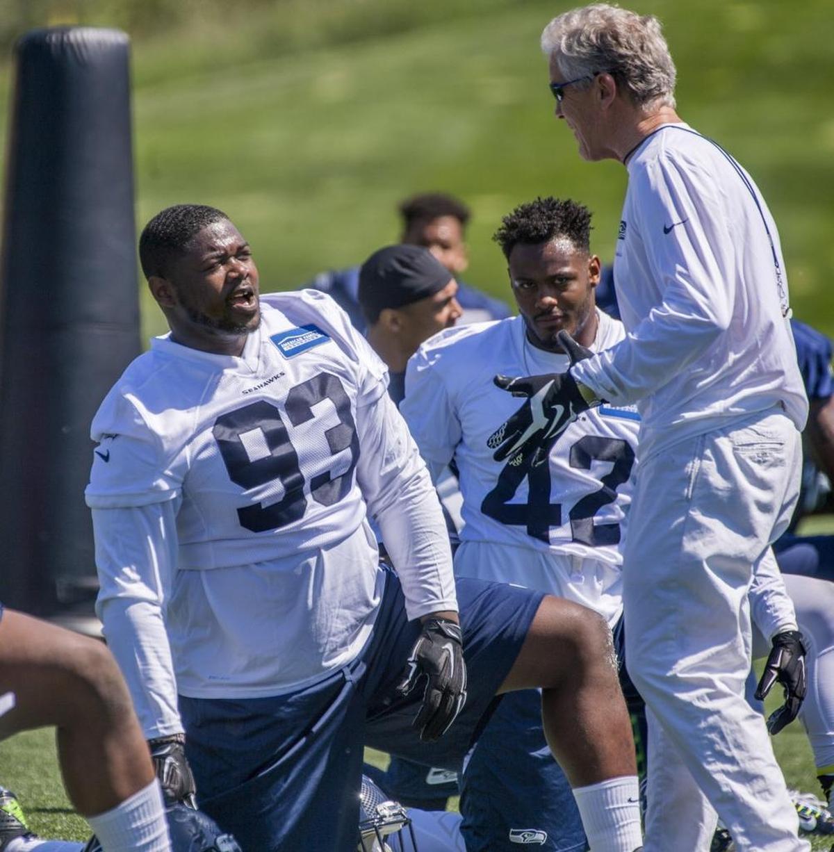 Defensive tackle Jarran Reed talks with head coach Pete Carroll in practice at the Seattle Seahawks’ mini-camp at their facility Friday in Renton.