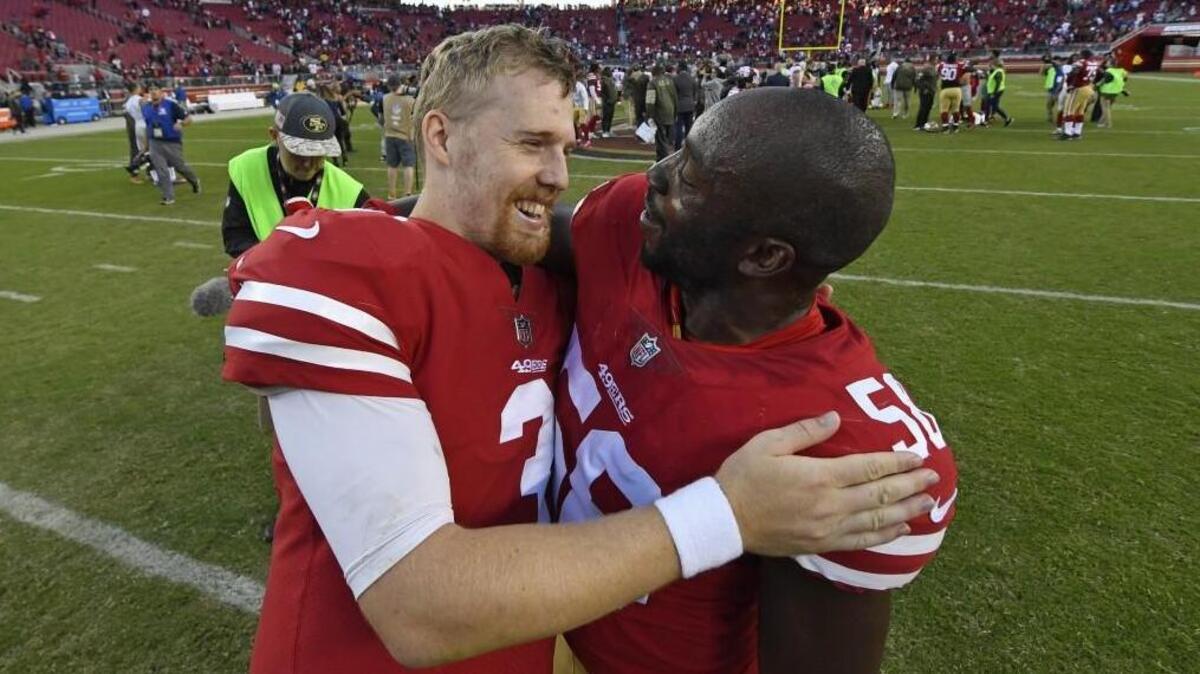 San Francisco 49ers quarterback C.J. Beathard, left, celebrates with teammate Elvis Dumervil =after their win against the New York Giants on Nov. 12. It was the first win of the season.