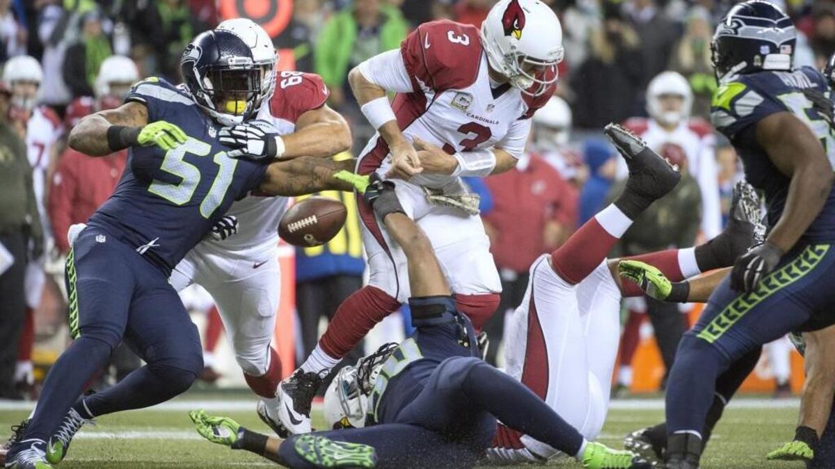 Seahawks linebacker Bruce Irvin (51) forces a fumble from Cardinals quarterback Carson Palmer during a Nov. 15 game in Seattle. Irvin, a 2012 first-round pick of the Seahawks, will be a free agent after the season.