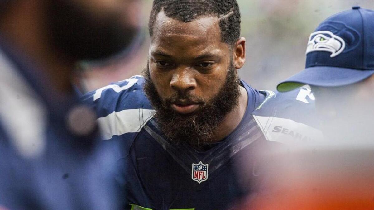 Seahawks defensive lineman Michael Bennett is led back to the bench after getting hurt in the third quarter. The Seattle Seahawks played the Atlanta Falcons in a NFL football game at CenturyLink Field in Seattle, Wash., on Sunday, October 16, 2016.