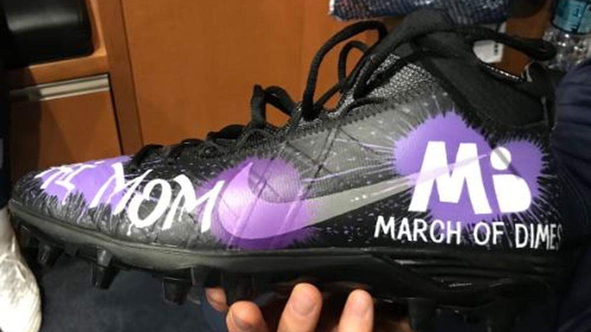 Long snapper Tyler Ott holds the charity cleats he’s going to wear on Sunday in the Seahawks’ home game against the San Francisco 49ers. He has a personal reasons to support the March of Dimes.