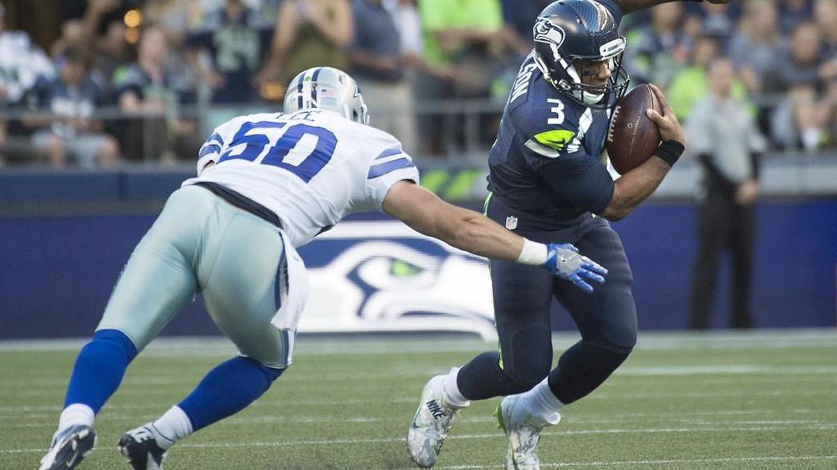 Seahawks quarterback Russell Wilson eludes the grasp of Dallas Cowboys linebacker Sean Lee during Thursday night's preseason NFL football game at CenturyLink Field in Seattle on Aug. 25, 2016.