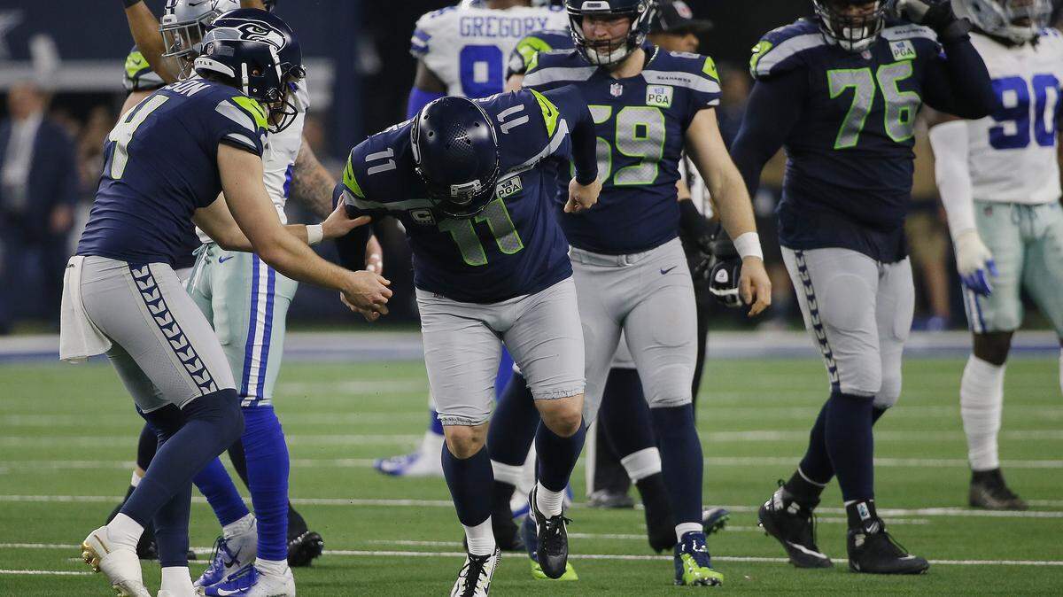 Seahawks kicker Sebastian Janikowski (11) falls to the ground after suffering a left hamstring attempting a 57-yard field-goal on the final play of the first half last weekend in Seattle’s wild-card playoff loss at Dallas. Friday, the Seahawks signed free-agent kicker Sam Ficken for 2019, increasing the possibility the team will let the 40-year-old Janikowski become a free agent in March rather than re-sign him.