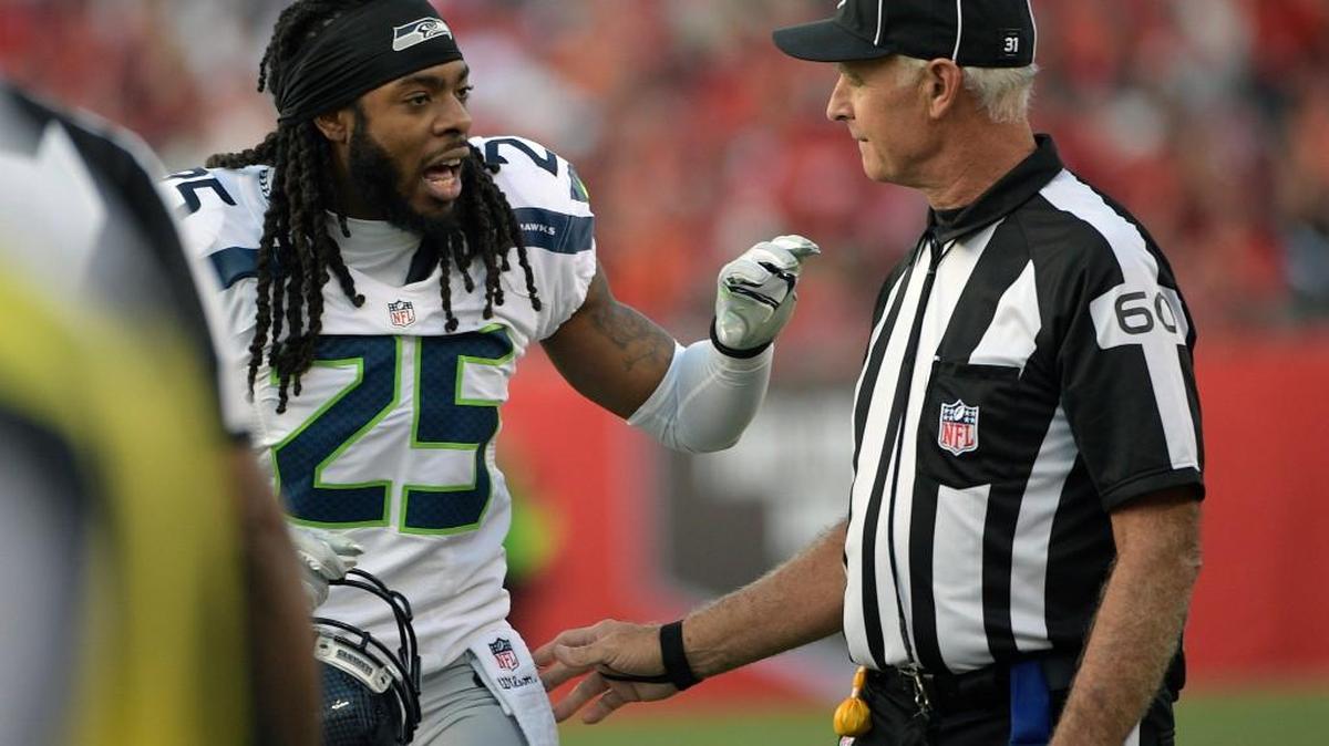 Seattle’s Richard Sherman, left, talks to side judge Gary Cavaletto during the first half.