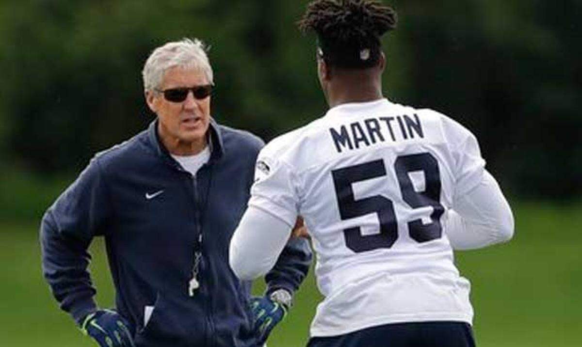 Rookie sixth-round draft choice Jacob Martin talks with coach Pete Carroll on the first day of the Seahawks' rookie minicamp last week at team headquarters in Renton.