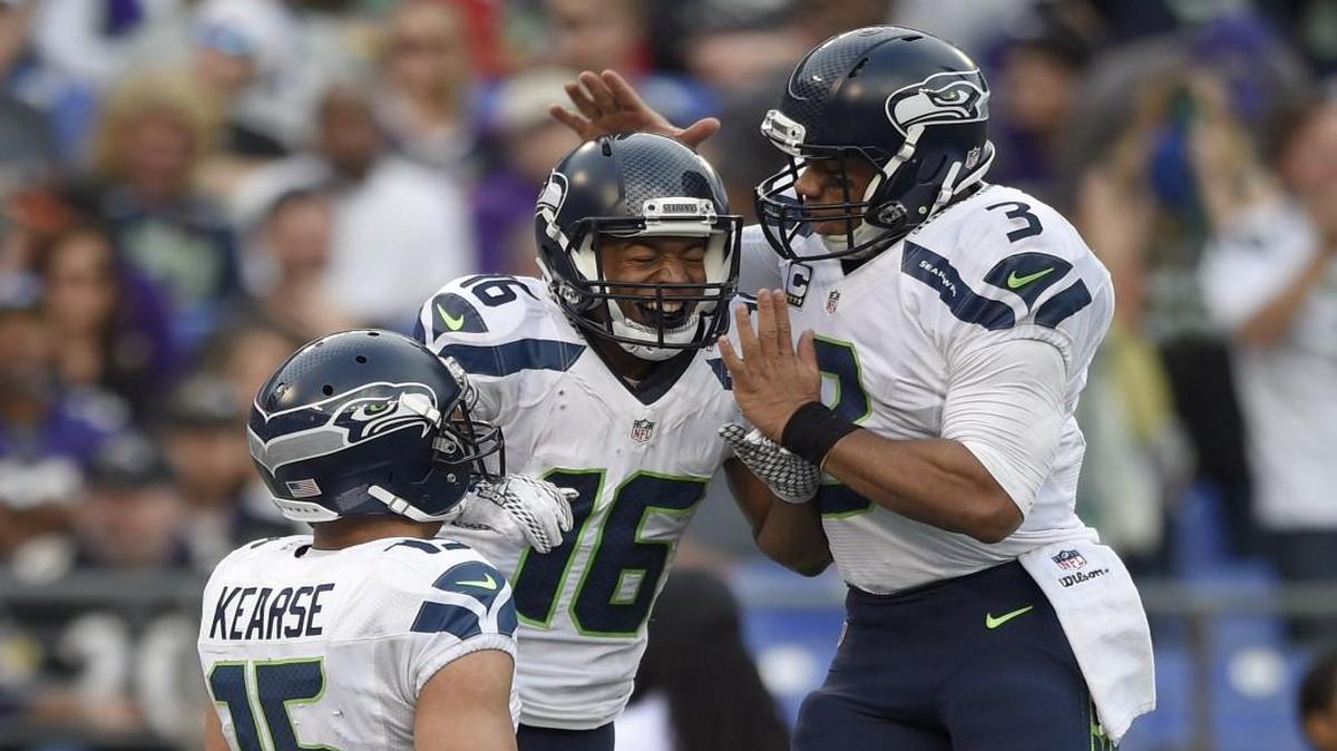 Seattle Seahawks wide receiver Jermaine Kearse (15) watches as Seahawks wide receiver Tyler Lockett (16) and Seahawks quarterback Russell Wilson (3) celebrate connecting for a touchdown during the second half an NFL football game against the Baltimore Ravens, Sunday, Dec. 13, 2015, in Baltimore.